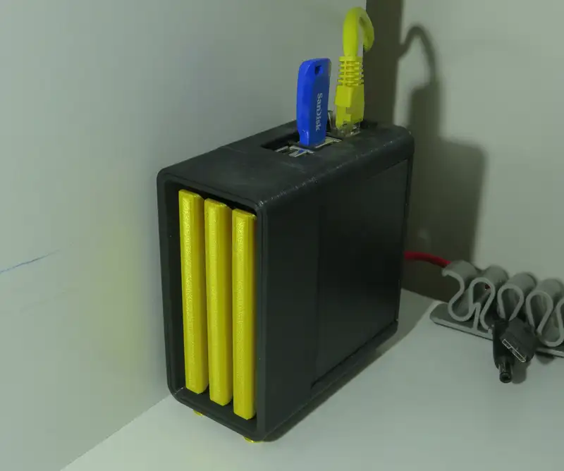 Picture showing my Raspberry Pi in its case sitting on my shelf